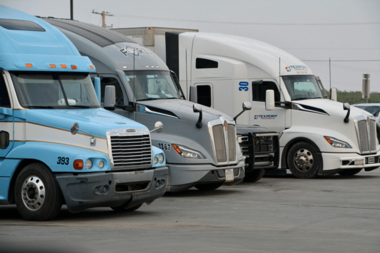 Parked semi trucks used for freight.